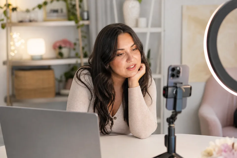 Creator checking messages from fans at her home studio desk